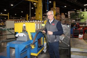 Paulo Ghigo, president of Tecnocap LLC in Glen Dale, holds some of the tinplate that is cut and ready to be used to create closures at the facility.